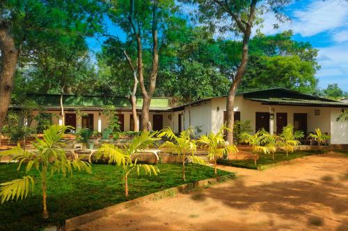 a house with a lot of trees in front of it at Lishan Nature Resort - Kataragama in Gotamegama