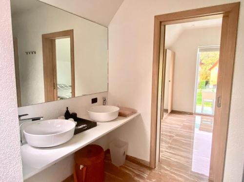 a bathroom with two sinks and a mirror at Juga Beach Front Villa 3B Koh Chang in Ko Chang