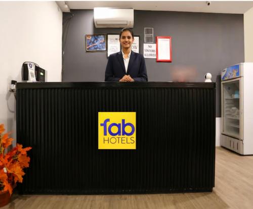 a woman is standing behind a reception desk at Via Urban Residency in New Delhi