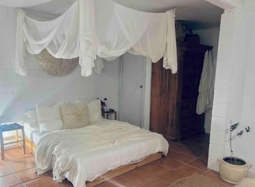 a bedroom with a bed with white drapes at Villa Saint George Byron Hinterland in Clunes