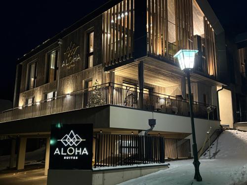 a building with a sign in front of it at night at Aloha Suite - Schladming Dachstein in Haus im Ennstal