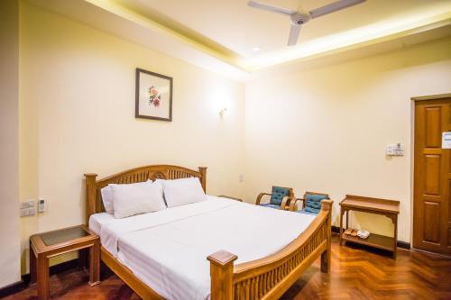 Postel nebo postele na pokoji v ubytování Prince Hotel Chiang Mai