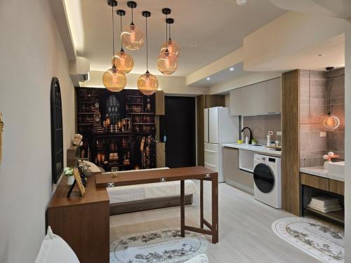 a kitchen with a table and some lights at 琥珀皇后館 Amber Queen Chambers in Taipei