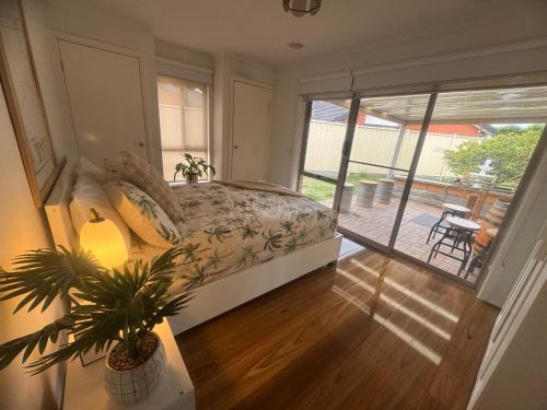 Taylors LakesにあるThe Welcome Innのベッドとガラスの引き戸のある寝室