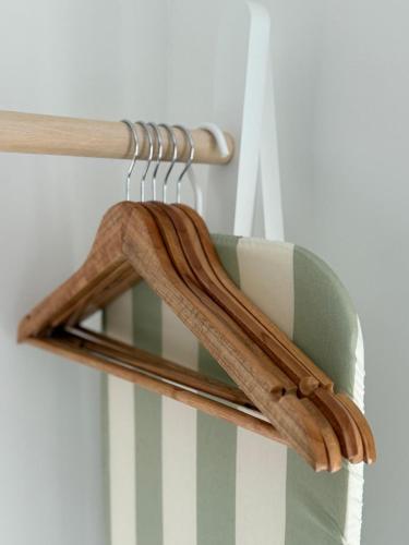 a wooden towel rack with a green and white stripes at The Little Fern in Oxford