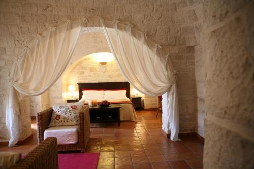Säng eller sängar i ett rum på Abate Masseria & Resort
