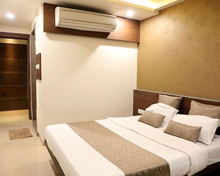 Habitación de hotel con cama y aire acondicionado en Adarsh Palace Hotel Near Bhopal Railway Station and Nadra Bus Stand Bhopal, en Bhopal