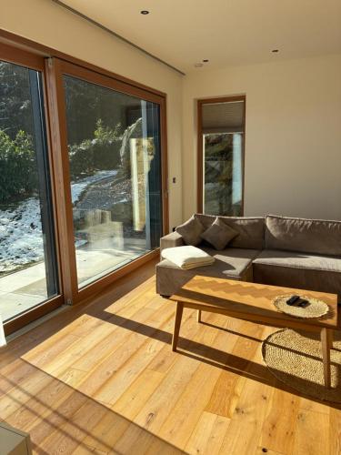 a living room with a couch and a coffee table at Anton's Apartment - Natur & See in Velden am Wörthersee