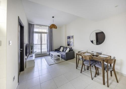 a living room with a table and a couch at Iconic HF BR Hall 2 Bath Balcony Free- Parking, Pool, Gym & 2 Kids - Al Reem Island in Abu Dhabi