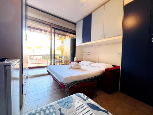 a room with two beds and a balcony at Suite Semeria 129 - Sanremo in Sanremo