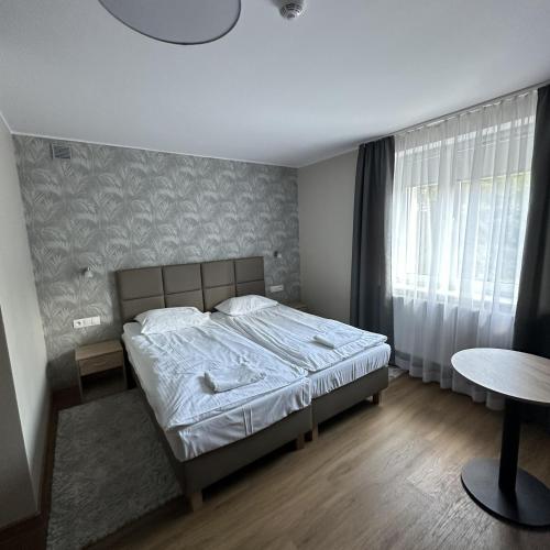 a bedroom with a bed and a table at GRACJA in Warsaw