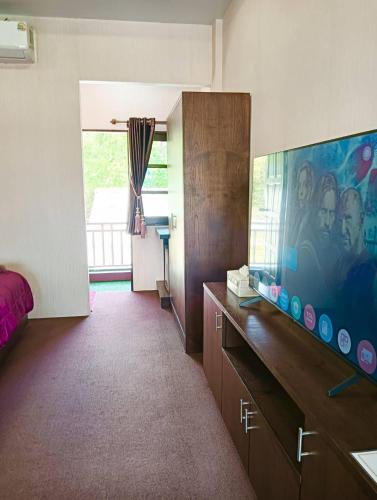 a living room with a large flat screen tv at Samui platinum hotel in Chaweng