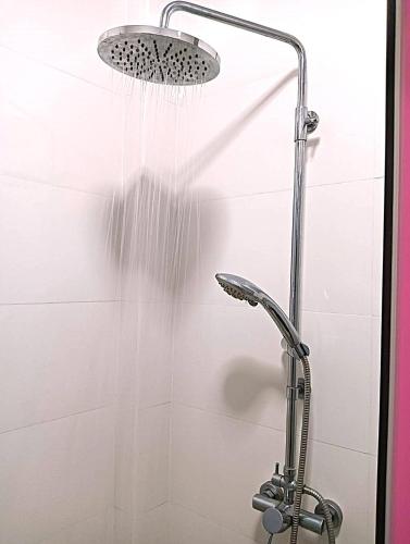 a shower with a shower head with water coming out of it at Samui platinum hotel in Chaweng