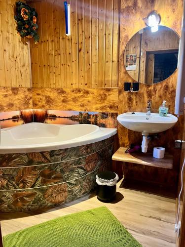 a bathroom with a bath tub and a sink at Norwegisches Holzhaus in Neuruppin