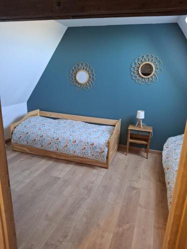 a bedroom with a bed and two mirrors on the wall at Le Lézard Flamand in Hazebrouck