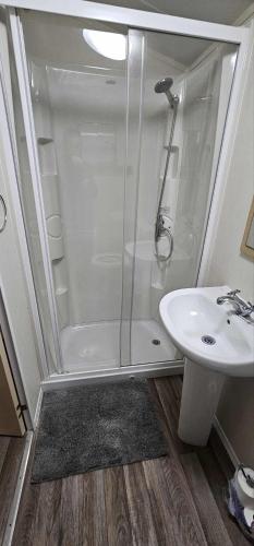 a bathroom with a shower and a sink at Sam's Caravan Hire in Ingoldmells