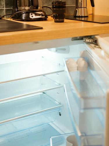 a refrigerator with its door open in a kitchen at Studio centre thermal touristique - Casa Amnéville in Amnéville
