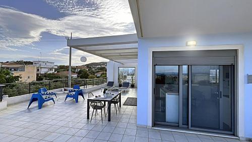 a balcony with a table and chairs on a building at Alba - Open Plan Apartment in Artemida