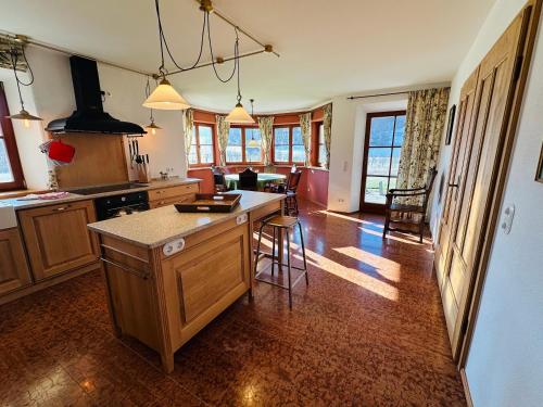 a kitchen with a island in the middle of a room at VILLA SEEBERG - by "Schloss Gessenberg" luxurious vacation home with lake and mountain views, suitable for families and friends in Petting