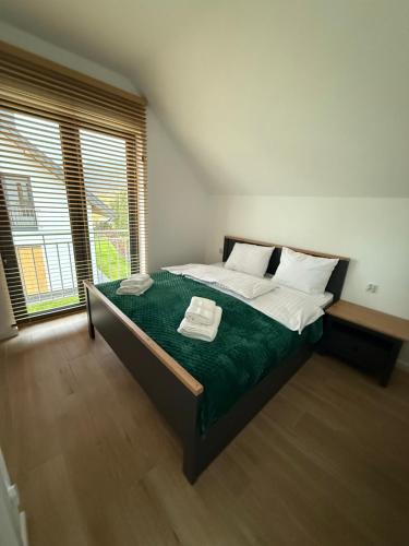 En eller flere senge i et værelse på Szumy Villas - Roztocze Huta Szumy