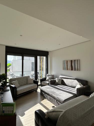 a living room with couches and a couch at Ayla golf luxury chalet in Aqaba