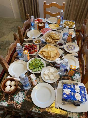 a table with plates of food and other foods at Leyla Eco Resort Queen Suites in Luxor