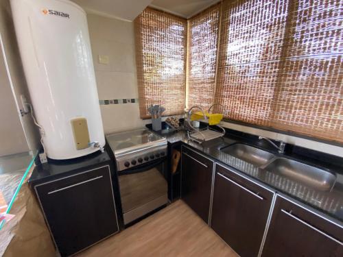 a kitchen with a sink and a stove at Villa Bella vista 2024 in San Rafael