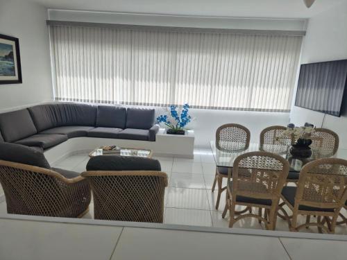 a living room with a couch and a table and chairs at Relax on the Beach in Guarujá