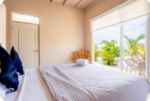 a bedroom with a bed and a large window at Ribera Del Norte Bungalows in Canoas