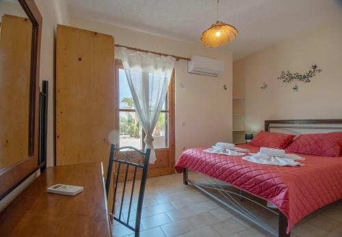 a bedroom with a bed and a table and a window at Istron Blue in Istron