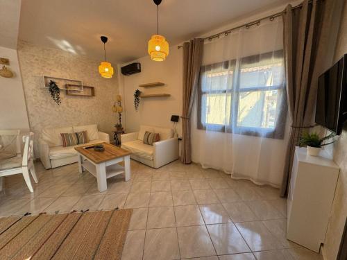 a living room with a couch and a table at Palm Villa in Skala Sotiros