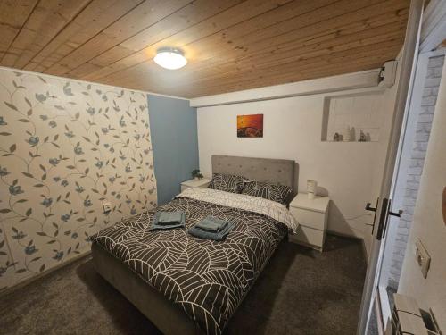 a bedroom with a bed with two bags on it at Casuta Din Poveste Gold Craiova in Craiova