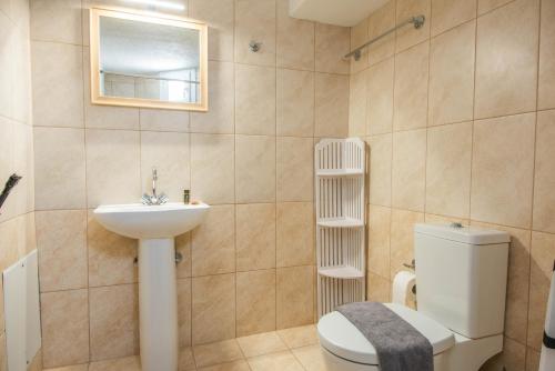 a bathroom with a toilet and a sink at Istron Blue in Istron