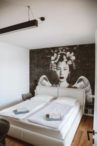 a bedroom with a bed with a painting on the wall at Villa Claudia in Kaštelir