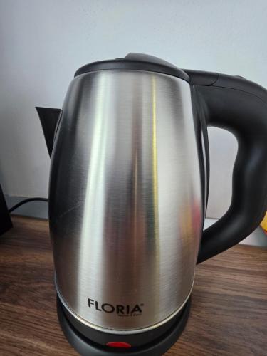 a toaster is sitting on a wooden table at Sya House in Craiova