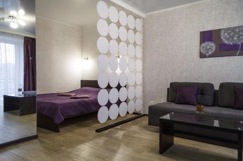 a living room with a bed and a couch at Exclusive apartment at the in Mykolaiv