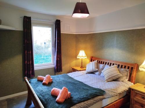 a bedroom with a bed with two teddy bears on it at Lovely place at Stenhouse in Edinburgh