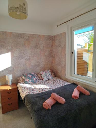 a bedroom with a bed with two towels on it at Lovely place at Stenhouse in Edinburgh
