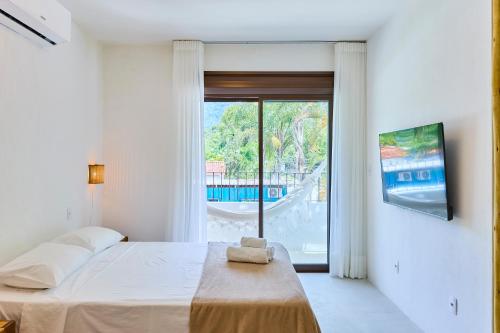 En eller flere senge i et værelse på Villa da Barra Ubatuba