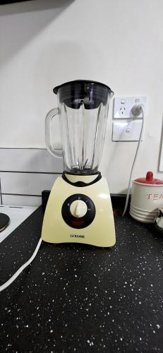 a blender sitting on top of a counter at Entire House 15 min CBD Near Beach Mall and Nature in Auckland