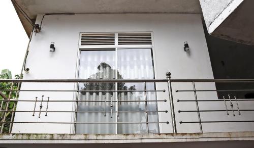 a balcony with a window with a curtain at Skylar Homestay - Comfortable Room with Balcony in Panwila Kandy in Panwila