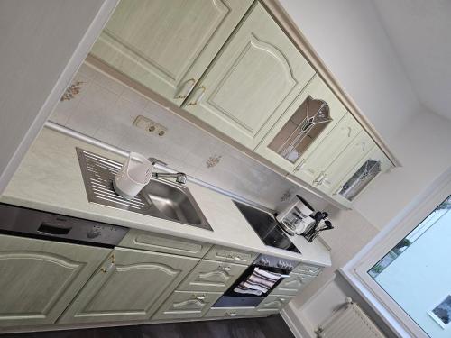 a kitchen with white cabinets and a sink at Seegarten in Görlitz