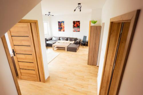 a room with a door open to a living room at Beskid Penthouse Milówka in Milówka