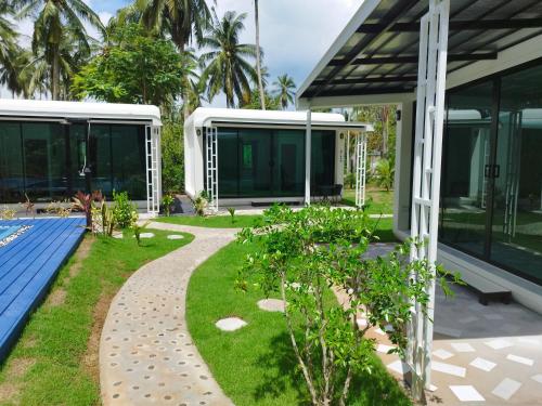 a house with a walkway next to a building at Samui Land Haven in Amphoe Koh Samui