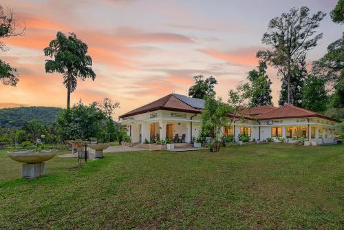 a house with a yard with a fountain at The Tusker's Hideout in Alawwa