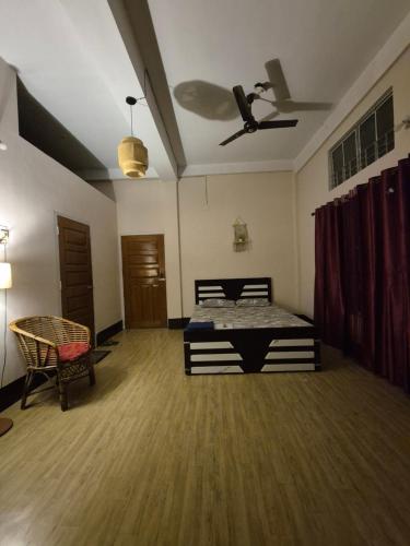 a bedroom with a bed and a ceiling fan at Destiny Home stay in Tezpur