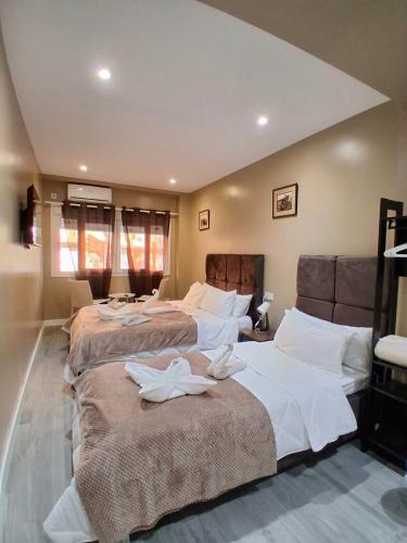 a bedroom with three beds with white sheets on them at AS ROOMS Alicante in Alicante