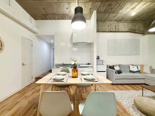 a kitchen and living room with a table and chairs at b hotel Nikke - 1BR Apt for 10ppl near Hondori Shopping in Hiroshima