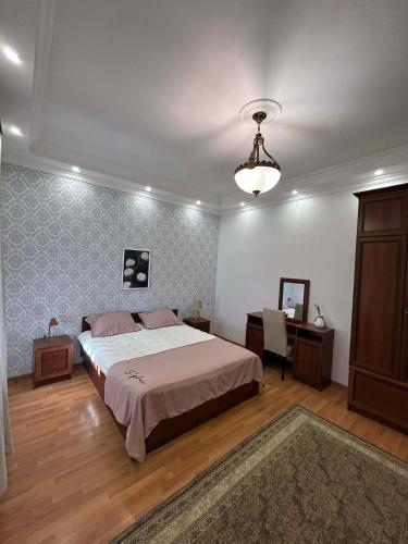 a bedroom with a bed and a table and a mirror at Apartment 9 in Mtskheta