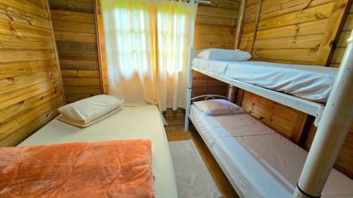 En eller flere senge i et værelse på Chácara Caminho do Paraíso